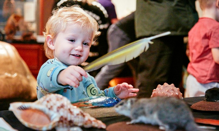 A child plays with a feather